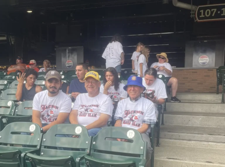 A group of trip participants together in the stadium stands